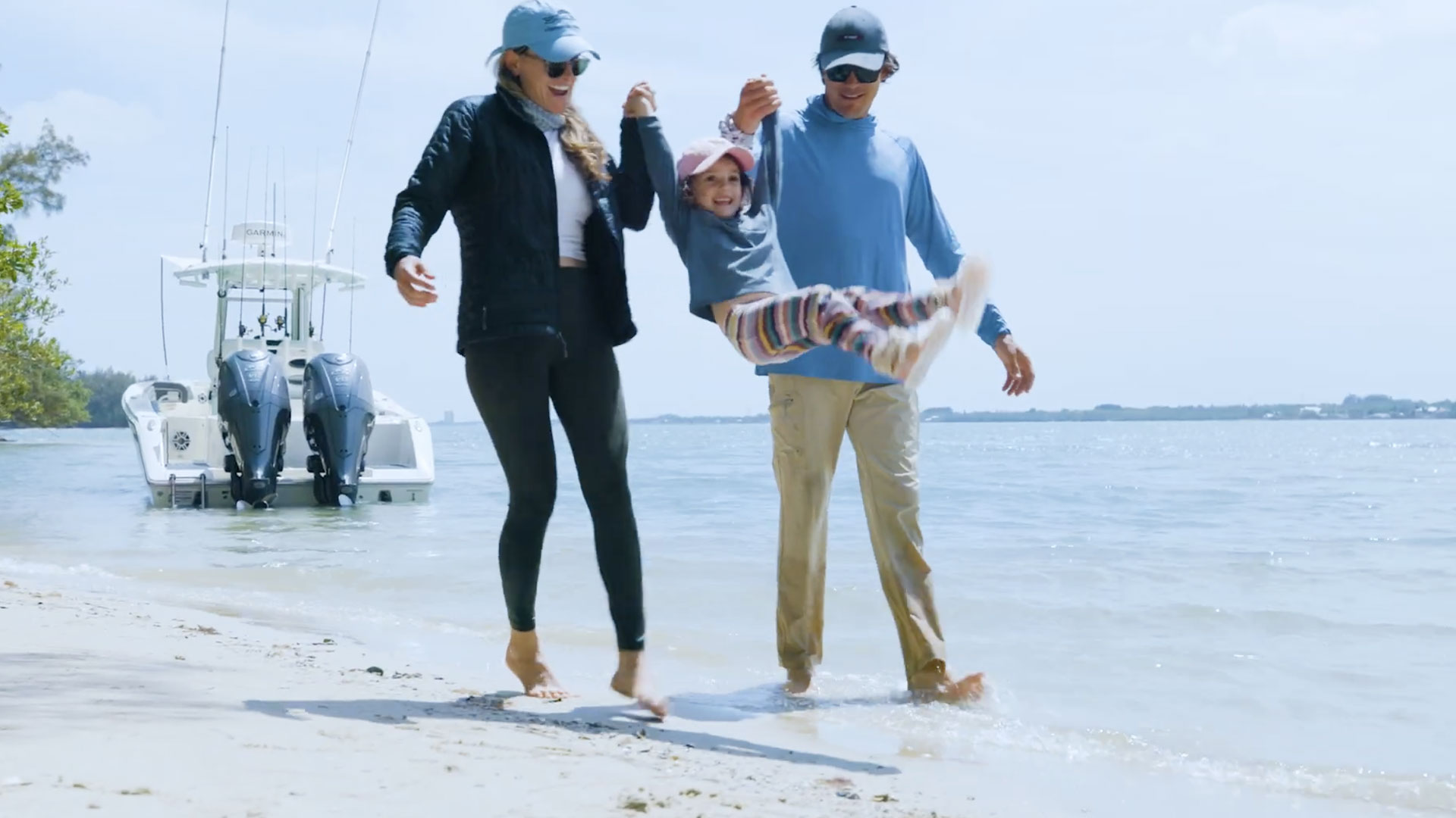 Cobia 265 cc family waking with child infront of boat