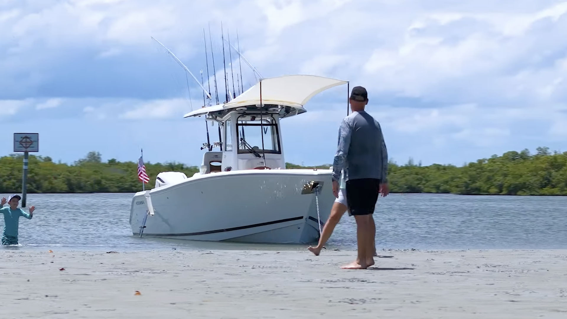 people by boat playing football on land
